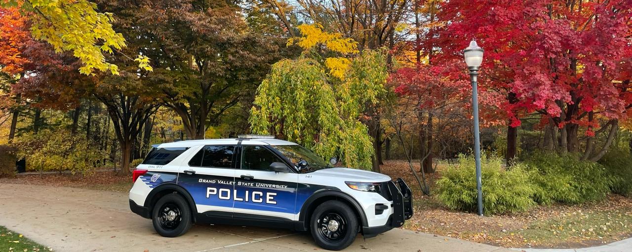 GVPD Police cruiser parked on path in front of colorful trees in autumn